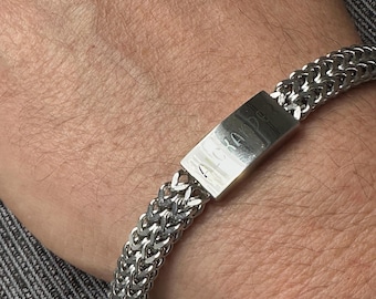 May include: A silver chain bracelet with a rectangular tag that says "808" on it.