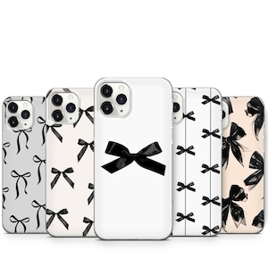 May include: Five different phone cases with a black bow pattern. The cases are clear and show the phone's camera lens. The bow pattern is repeated on each case, but the background color varies.