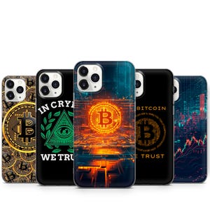 May include: Five different iPhone cases with a Bitcoin theme. The cases feature a variety of designs, including a glowing Bitcoin logo, a pyramid with an eye, and a Bitcoin logo with the text "In Crypto We Trust".