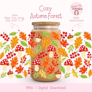 May include: A glass can wrap with a cosy autumn forest design. The wrap features illustrations of red-capped mushrooms, orange and yellow leaves, red berries, and acorns. The text "Cozy Autumn Forest" is displayed on the wrap. The size is 24.77 cm x 12.7 cm.