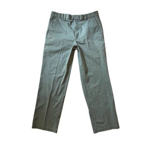 May include: Khaki-coloured trousers with a straight-leg cut. The pants have a button and zip fastening, belt loops, and pockets at the front and back. The material looks like a hard-wearing cotton blend, suitable for casual or semi-formal wear.