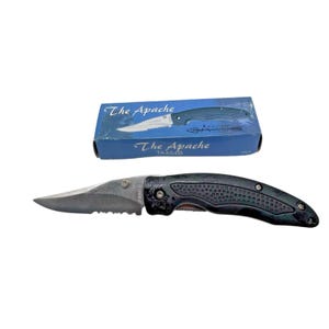 May include: A black and silver folding knife with a serrated edge, next to its blue box. The knife has a textured handle and the text "The Apache" is printed on the box and the blade. The box also has the text "TA454B".