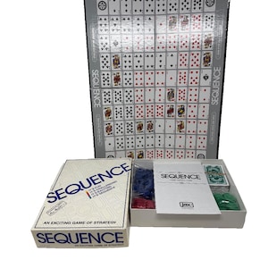 May include: A Sequence board game set featuring a large folding game board printed with a grid of playing cards, a white cardboard box with blue text, and an open box containing blue and green plastic chips and two decks of playing cards.
