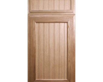 May include: A light brown wooden cabinet door with a raised panel design. The door features vertical grooves in the center panel and a rectangular top panel. The frame is a lighter shade of brown.