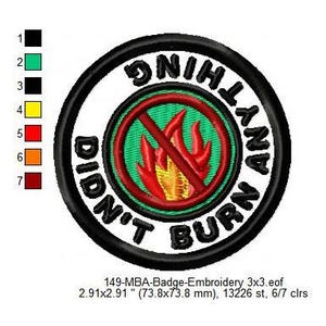 May include: Embroidered patch with the text "DIDN'T BURN ANYTHING" in black, encircling a red and yellow flame symbol with a red slash. The patch is 73.8 mm in diameter, with a black border and a white background.