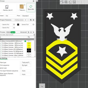 May include: A black and yellow US Navy insignia, with a white eagle, stars, and chevrons. The design is set against a dark background, with a textured appearance. The image is likely a digital rendering or 3D model.