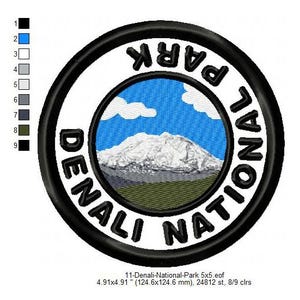 May include: A black and white embroidered patch with the text "Denali National Park" in a circle. The patch features a mountain range with a snowy peak and a blue sky with white clouds.