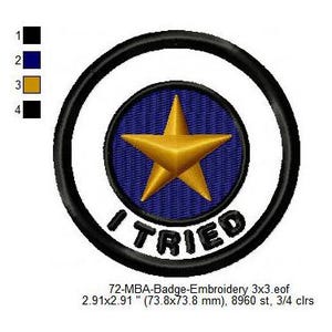 May include: A round, white embroidered patch with a black outline. The center of the patch features a blue circle with a gold star. The text "I TRIED" is written in black below the circle.