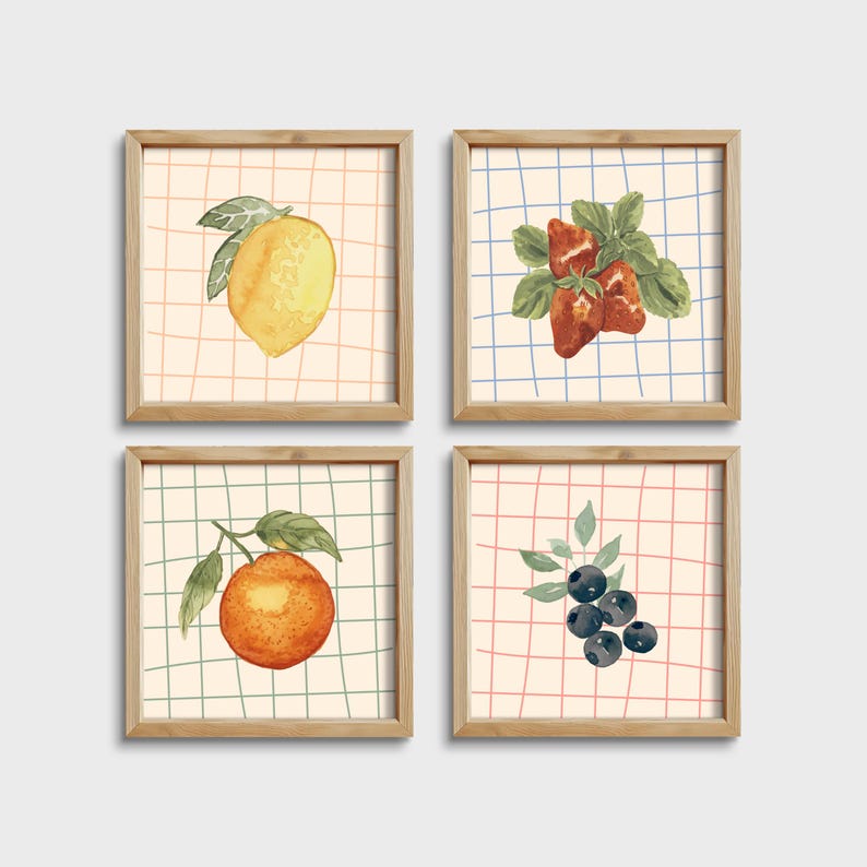 May include: Four framed prints with a white background and a grid pattern in different colors. Each print features a watercolor illustration of a different fruit: a lemon, strawberries, an orange, and blueberries.