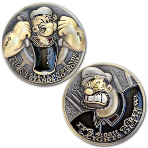 May include: Two collectible coins featuring Popeye the Sailor. One coin shows Popeye flexing his biceps with the text "THAT'S ALL I CAN STANDS NO MORE." The other coin shows Popeye with the text "IT'S 9:00!! LIGHTS OUT!! CURFEW!"