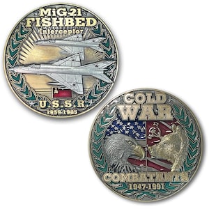 May include: Two commemorative coins. One features a MiG-21 Fishbed Interceptor with text, "U.S.S.R. 1959-1985." The other coin has an eagle and bear facing each other, with text, "COLD WAR COMBATANTS 1947-1991."