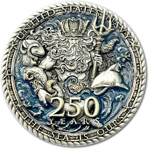 K&ouml;nnte beinhalten: Eine Silberm&uuml;nze zum 250-j&auml;hrigen Jubil&auml;um der United States Navy. Die M&uuml;nze zeigt Neptun mit einem Dreizack, umgeben von Meereslebewesen und der Aufschrift "THE SEAS IS OURS".