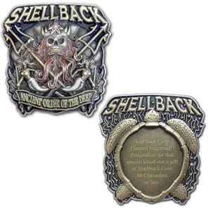 May include: Two metal Shellback coins. One coin features a skull with tentacles, tridents, and mermaids, with the text "ANCIENT ORDER OF THE DEEP". The other coin has a turtle design and text that reads "Get Your Coin Custom Engraved!"