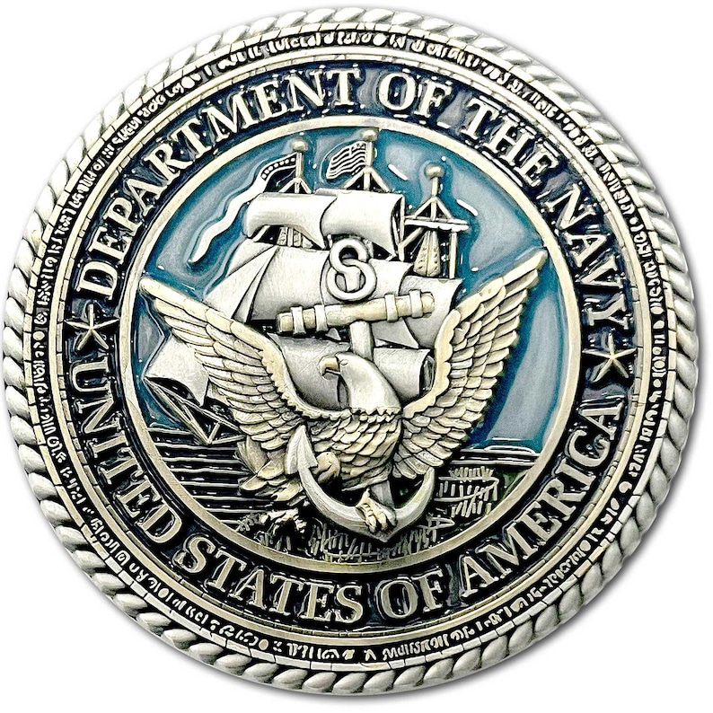 K&ouml;nnte beinhalten: Eine silberfarbene M&uuml;nze des US-Marineministeriums. Die M&uuml;nze zeigt ein detailliertes Emblem mit einem Schiff, einem Adler, einem Anker und dem Text "DEPARTMENT OF THE NAVY" und "UNITED STATES OF AMERICA". Die M&uuml;nze hat einen seilartigen Rand.