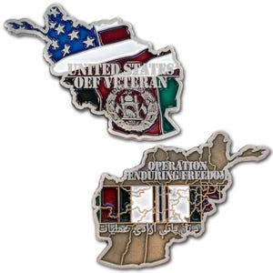 May include: Two metal pins in the shape of Afghanistan. One pin features the American flag and the text "UNITED STATES OFF VETERAN". The other pin reads "OPERATION ENDURING FREEDOM". Both pins have intricate details and colorful enamel.