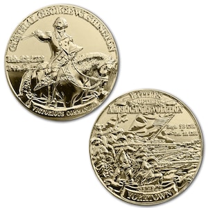 May include: Two gold-colored commemorative coins. One coin features General George Washington on horseback with the text "Victorious Commander." The other coin depicts a battle scene with the text "Battles of the American Revolution" and "Siege of Yorktown."