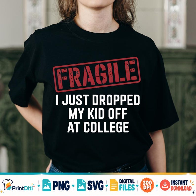 May include: A black short-sleeve t-shirt featuring a red rectangular stamp graphic with the word FRAGILE in distressed lettering. Below the stamp, the white text reads I JUST DROPPED MY KID OFF AT COLLEGE in a bold, sans-serif font style.