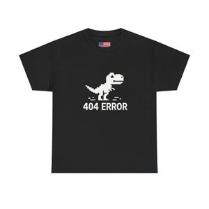 May include: Black t-shirt featuring a white pixelated dinosaur and the text "404 ERROR" printed on the front.