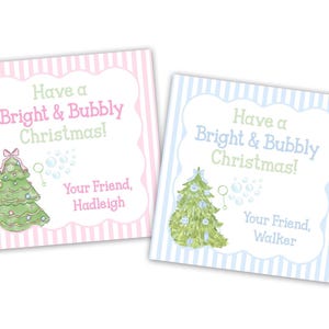 May include: Two Christmas cards with striped backgrounds. One is pink and the other is blue. Each card has a Christmas tree illustration and the text "Have a Bright & Bubbly Christmas!" with a name below.