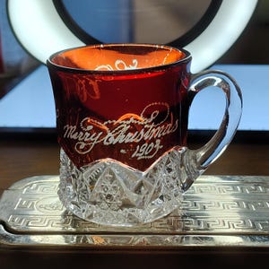 May include: A set of three ceramic mugs with a speckled, matte finish. The mugs are in shades of cream, light gray, and dark gray. Each mug has a simple, minimalist design and a rounded handle.