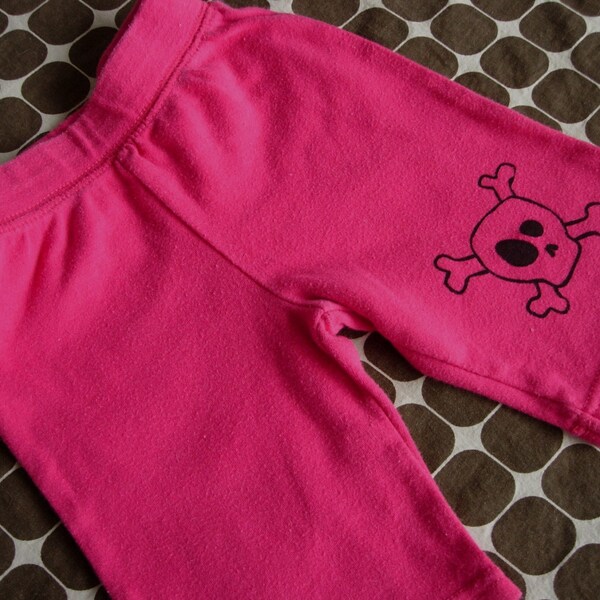 Pink baby skull and crossbone pants. Size 3 months.