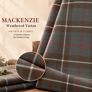 May include: Fabric featuring the Mackenzie Weathered Tartan pattern in shades of gray and brown with thin white and red intersecting lines. Text on the image reads: MACKENZIE Weathered Tartan PREMIUM FABRIC A Timeless Pattern for Modern Living.