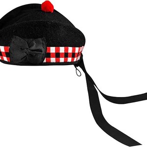 May include: Black beret with a red and white checked band and a black bow. The beret has a red pom-pom on top and a black ribbon.