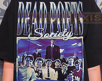May include: Black t-shirt featuring the text "DEAD POETS Society" in a stylized, iridescent font. The shirt displays a graphic of a group of men in suits and sweaters. The design has a vintage, retro aesthetic.