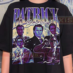 May include: Black t-shirt featuring a graphic design with the text "PATRICK BATEMAN" in a stylized font. The design includes multiple images of a man in various poses, with lightning bolt accents.