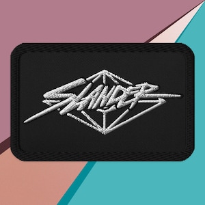 May include: Black embroidered patch with a white diamond shape and the word "Stance" written in a stylized font.