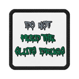 May include: Embroidered patch with a black border and white background. The patch features the text "DO NOT FEED THE ALIEN DRUGS" in gray and green, stylized lettering.