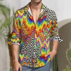 Puede incluir: Una camisa de manga larga con botones y un estampado abstracto colorido de líneas onduladas y goteantes en tonos de rojo, naranja, amarillo, verde, azul y morado. El estampado está sobre un fondo blanco y negro.