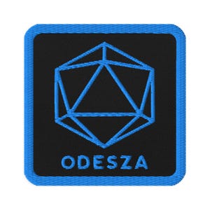 May include: A blue and black embroidered patch with a geometric design and the word "ODESZA" in white.