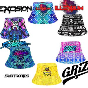 May include: Collection of bucket hats with various designs and logos. Includes hats with the text "EXOSION", "ILLENIUM", "SLANDER", "GRIZ", and "SUBTRONICS". The hats feature geometric patterns, graphic designs, and text.