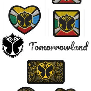Op de afbeelding: Een verzameling geborduurde patches met het Tomorrowland-logo, in ronde, ovale, hartvormige en vierkante vormen. Sommige patches hebben een meerkleurig ontwerp met groen, blauw, rood en geel, terwijl andere goud en zwart van kleur zijn.