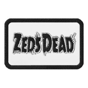 May include: Black and white embroidered patch with the text "ZEDS DEAD" in a stylised font.