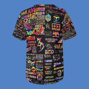 May include: Black short-sleeved button-up shirt with a vibrant, multicolored design. The shirt is covered in the names and logos of various DJs and music artists, creating a bold and eye-catching pattern. The shirt's design includes the text "SPARKS", "CHAINSMOKE", and "CALVIN HARRIS".