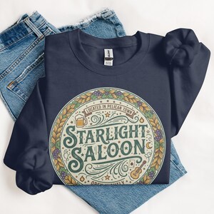 Starlight Saloon T-Shirt, Retro Graphic Tee, Vintage Style Shirt, Pelican Town Tee, Gift for Gamers, Cozy Gaming Apparel, Unisex Fit