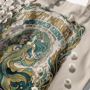Night Market Mermaid Show tote bag with teal and gold artwork.