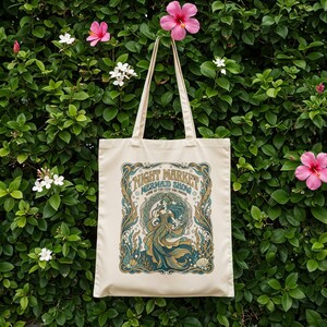 Cream tote bag with "Night Market Mermaid Show" text and sea-themed illustration.
