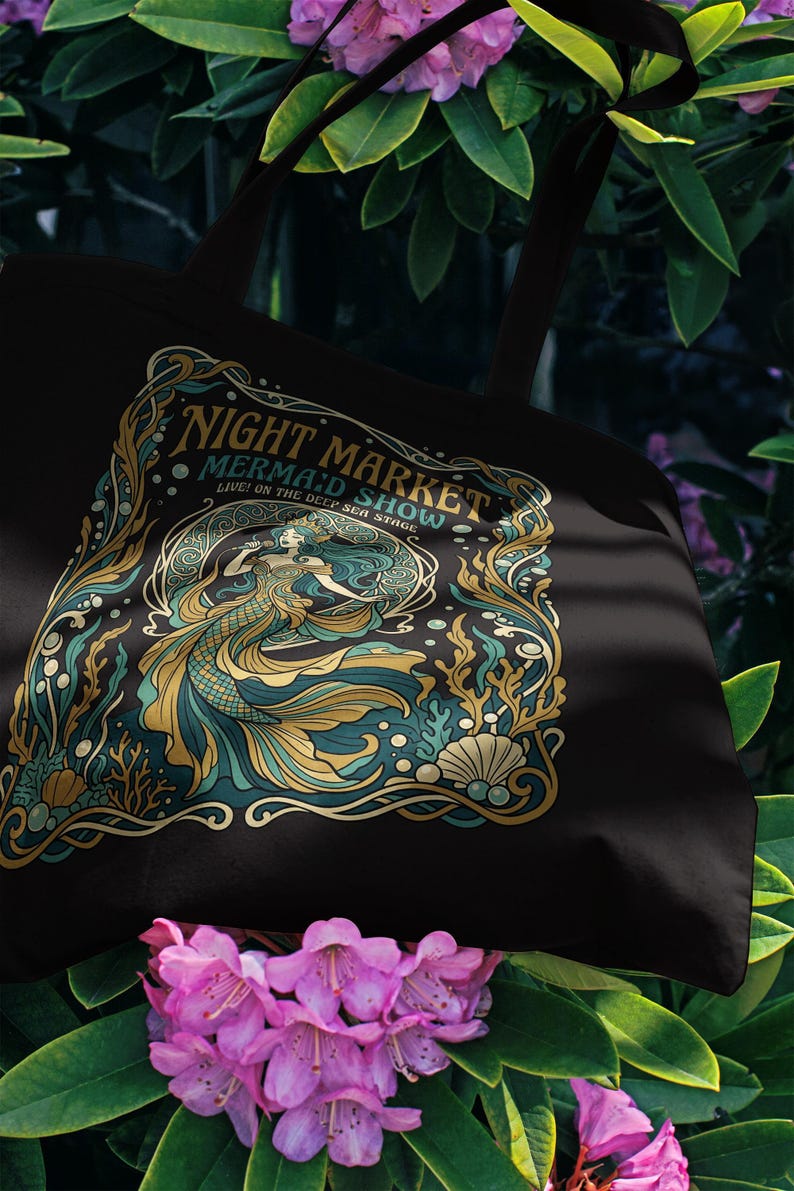 Black tote bag with "Night Market Mermaid Show" art nouveau design.