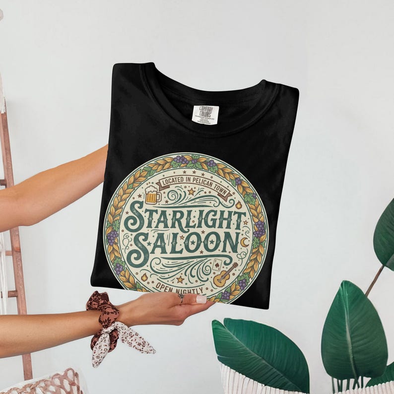 Starlight Saloon Graphic Tee, Retro Pelican Town T-Shirt, Vintage Style Unisex Shirt, Fun and Nostalgic Design, Casual Wear