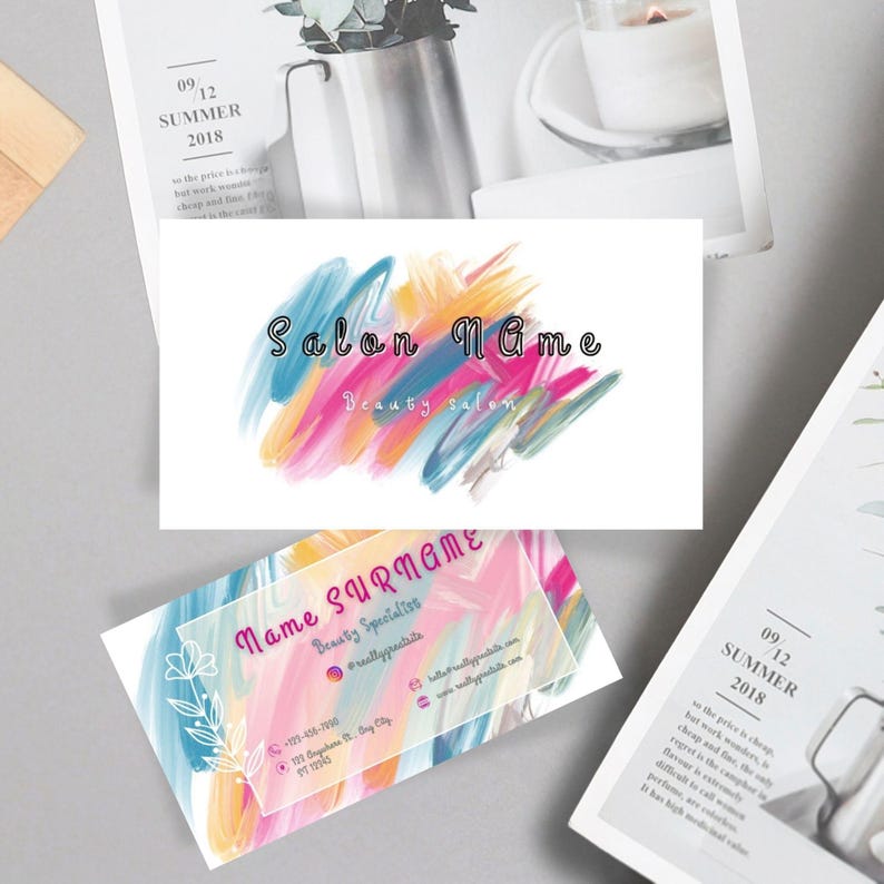 May include: Business cards with a colorful abstract design. One card features the text "Salon Name" and "Beauty salon." The other card has the text "Name Surname" and contact information. The cards are set against a neutral background.