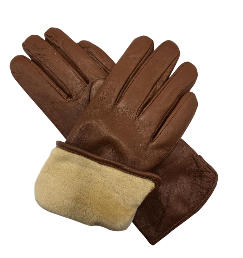 May include: A pair of brown leather gloves with a fleece lining. The gloves have a fold-over cuff.