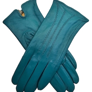 May include: A pair of teal blue leather gloves with a stitched design. The gloves are folded in half and the fingers are visible.