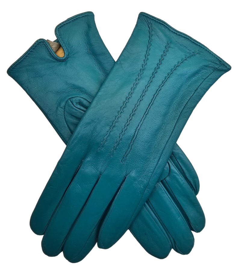 May include: A pair of teal blue leather gloves with a stitched design. The gloves are folded in half and the fingers are visible.