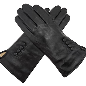 May include: A pair of black leather gloves with button detailing on the cuff.