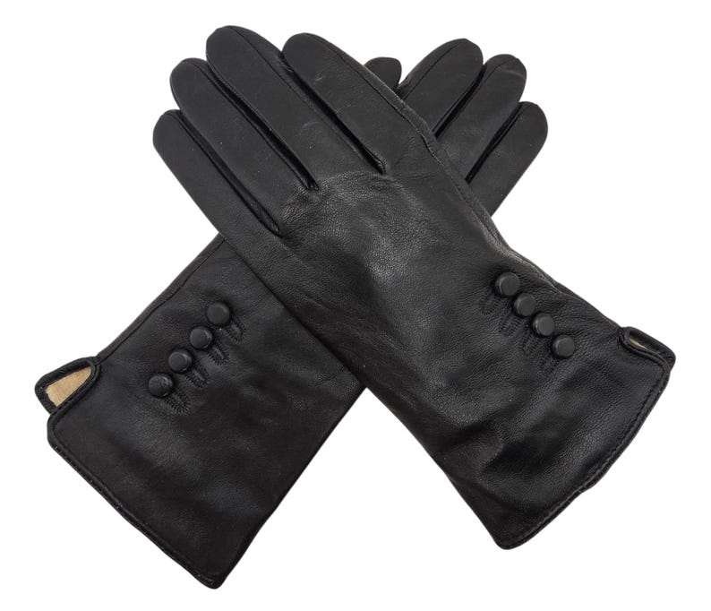 May include: A pair of black leather gloves with button detailing on the cuff.