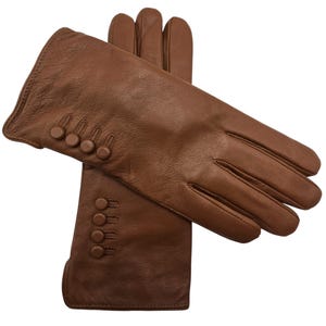 May include: A pair of brown leather gloves with button detailing on the cuff.
