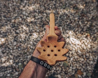 Handmade spalted maple pasta spoon with wide head and long tapered handle in warm amber tones
